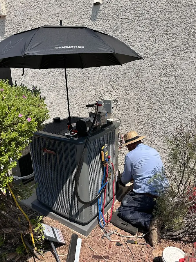 HVAC technician performing outdoor AC maintenance in DeBary
